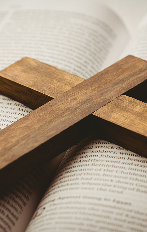 Open bible and wooden cross